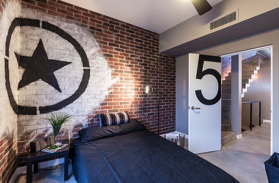 Industrial bedroom with brick walls, concrete floors, and graffiti art - Graffiti in interior design